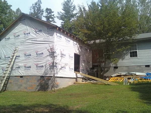 Tyvek wrapped gable on a new room addition beside an existing home in Folsom